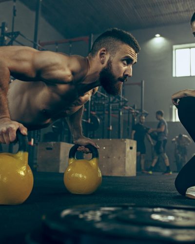 fit-young-man-lifting-barbells-working-out-in-a-gym.jpg